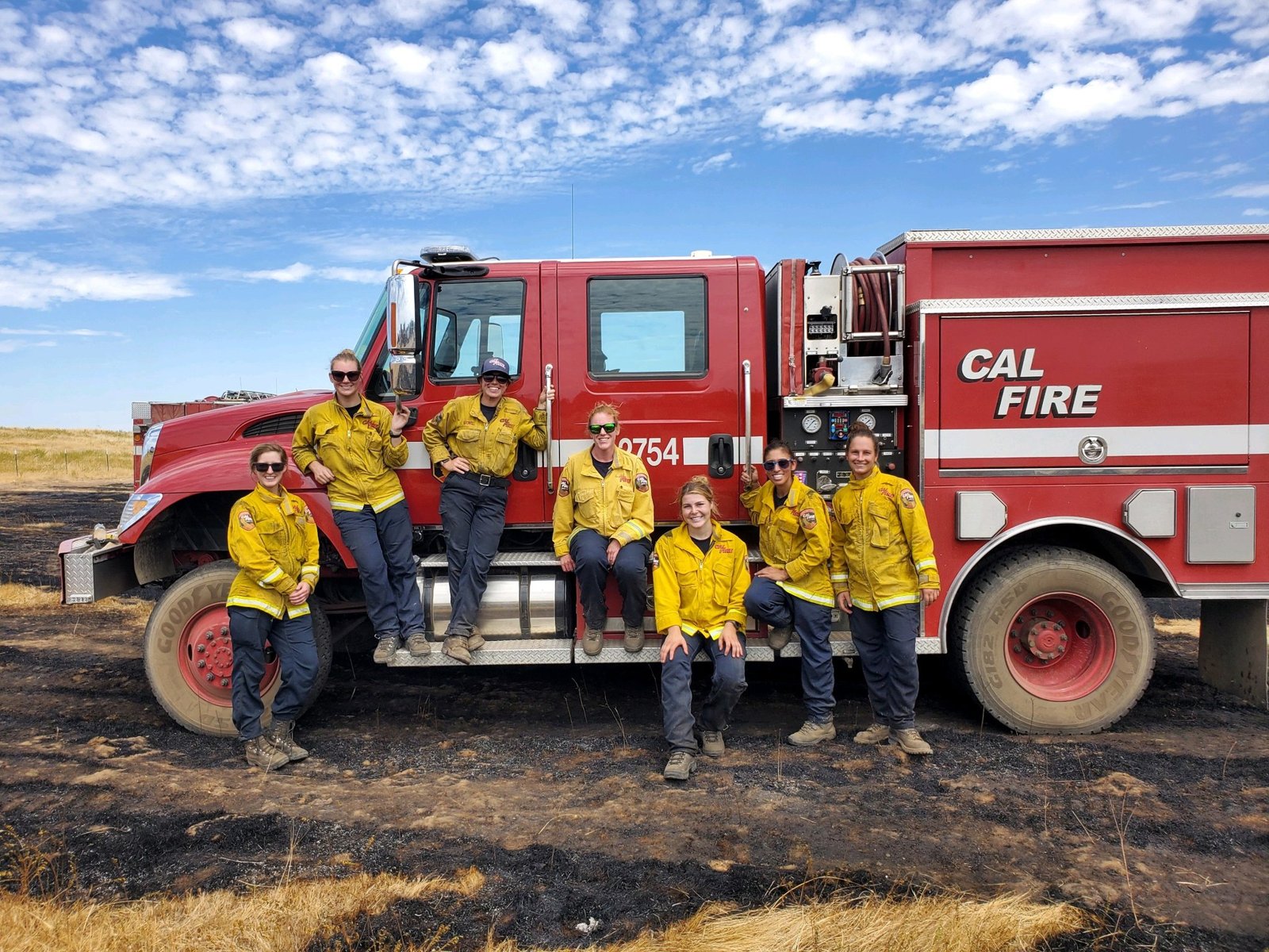 Women firefighters beside a CAL FIRE engine